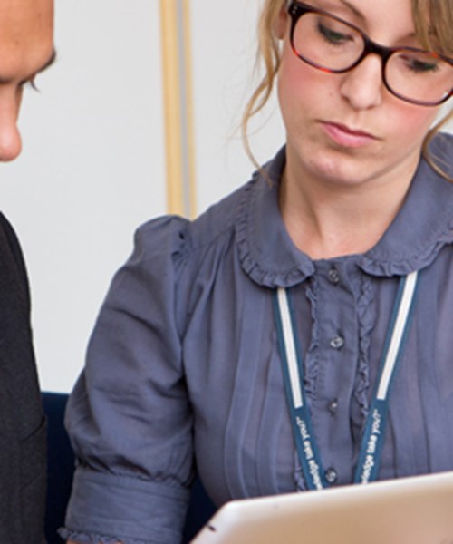Man and woman reviewing content on a tablet