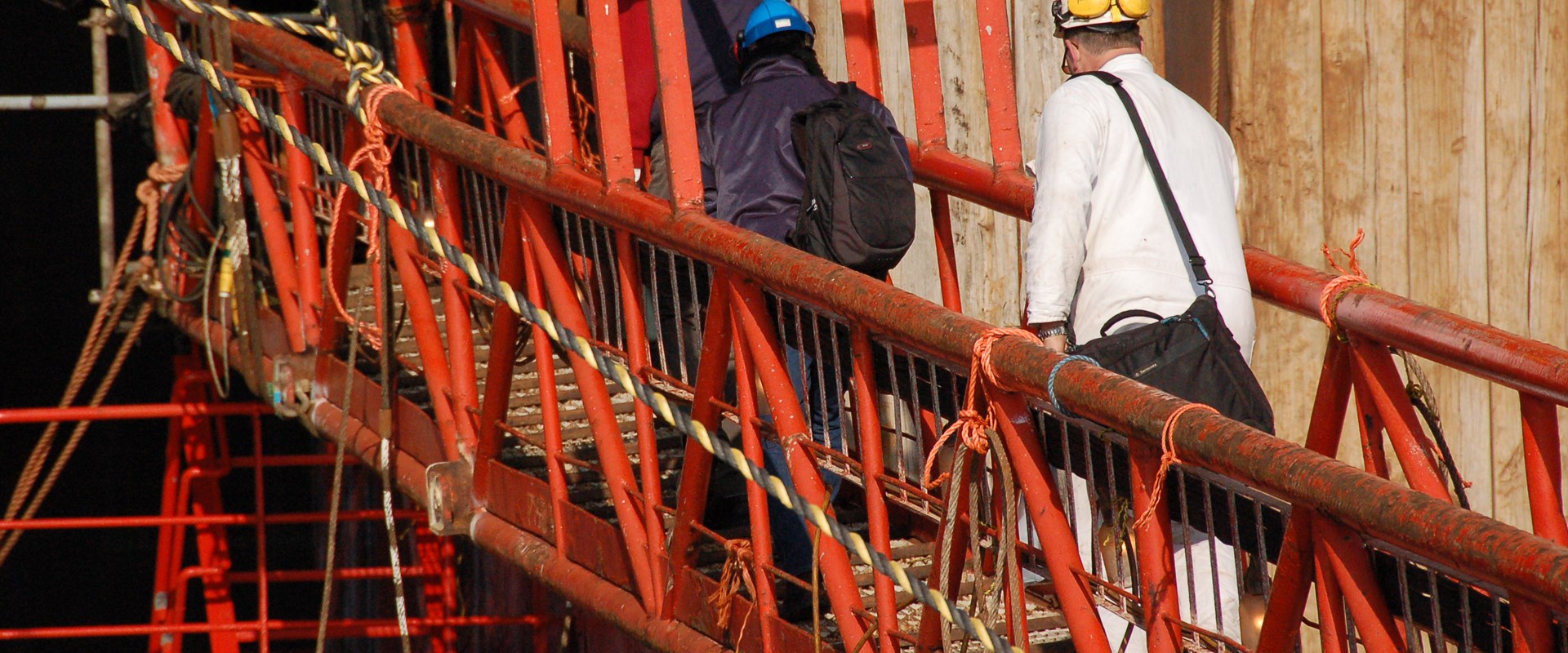 Engineer crossing a red bridge