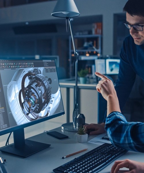 Data engineers looking at a screen. 