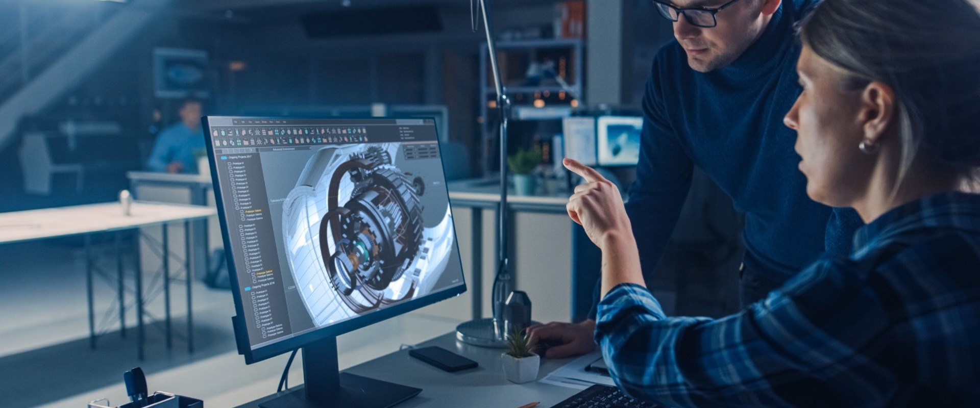 Data engineers looking at a screen. 
