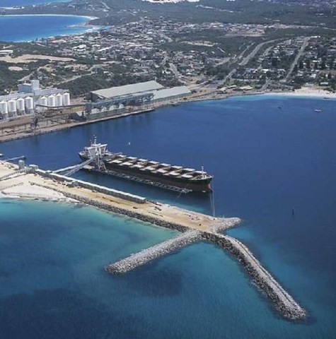 An aerial picture of a ship docked at a jetty