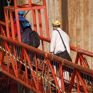 Engineer crossing a red bridge