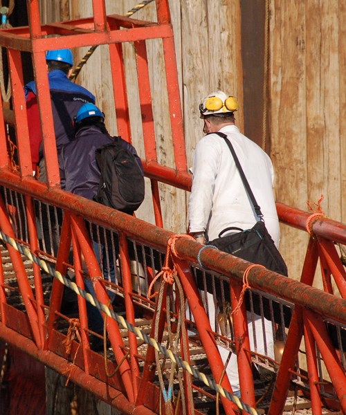 Engineer crossing a red bridge
